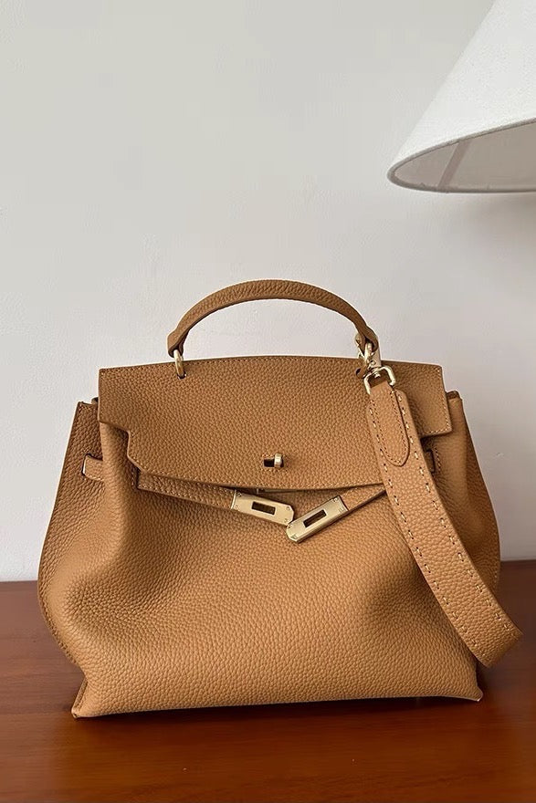 Structured top-handle leather satchel bag in tan, front view with removable strap