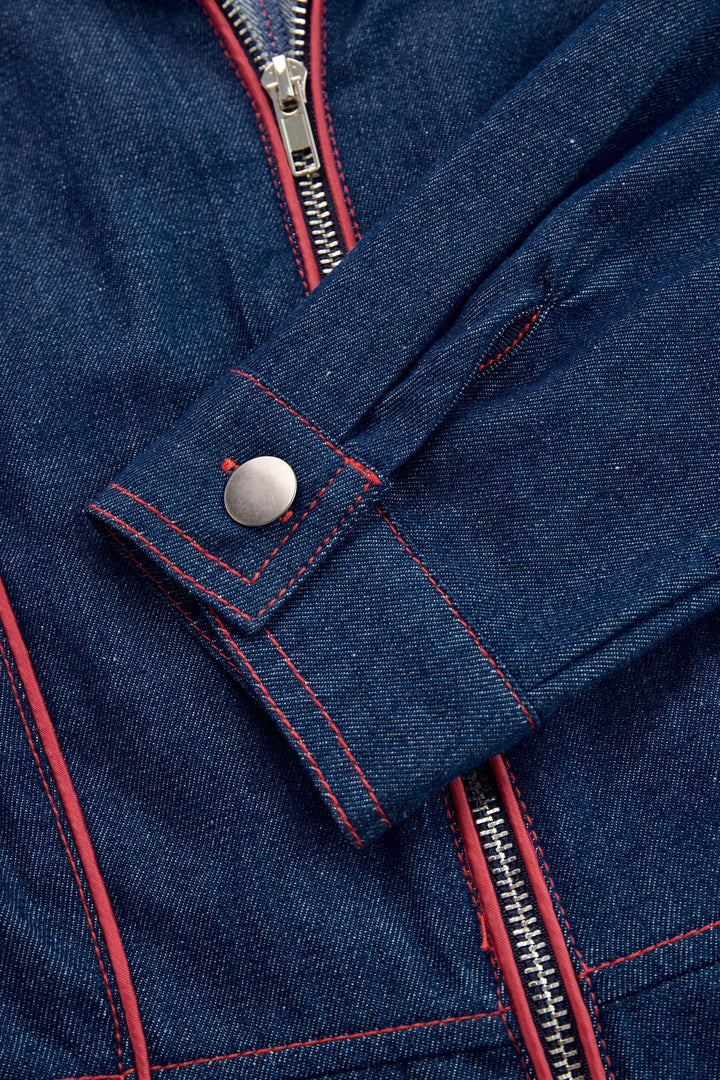 Cuff detail with metal snap and red stitching on denim jumpsuit