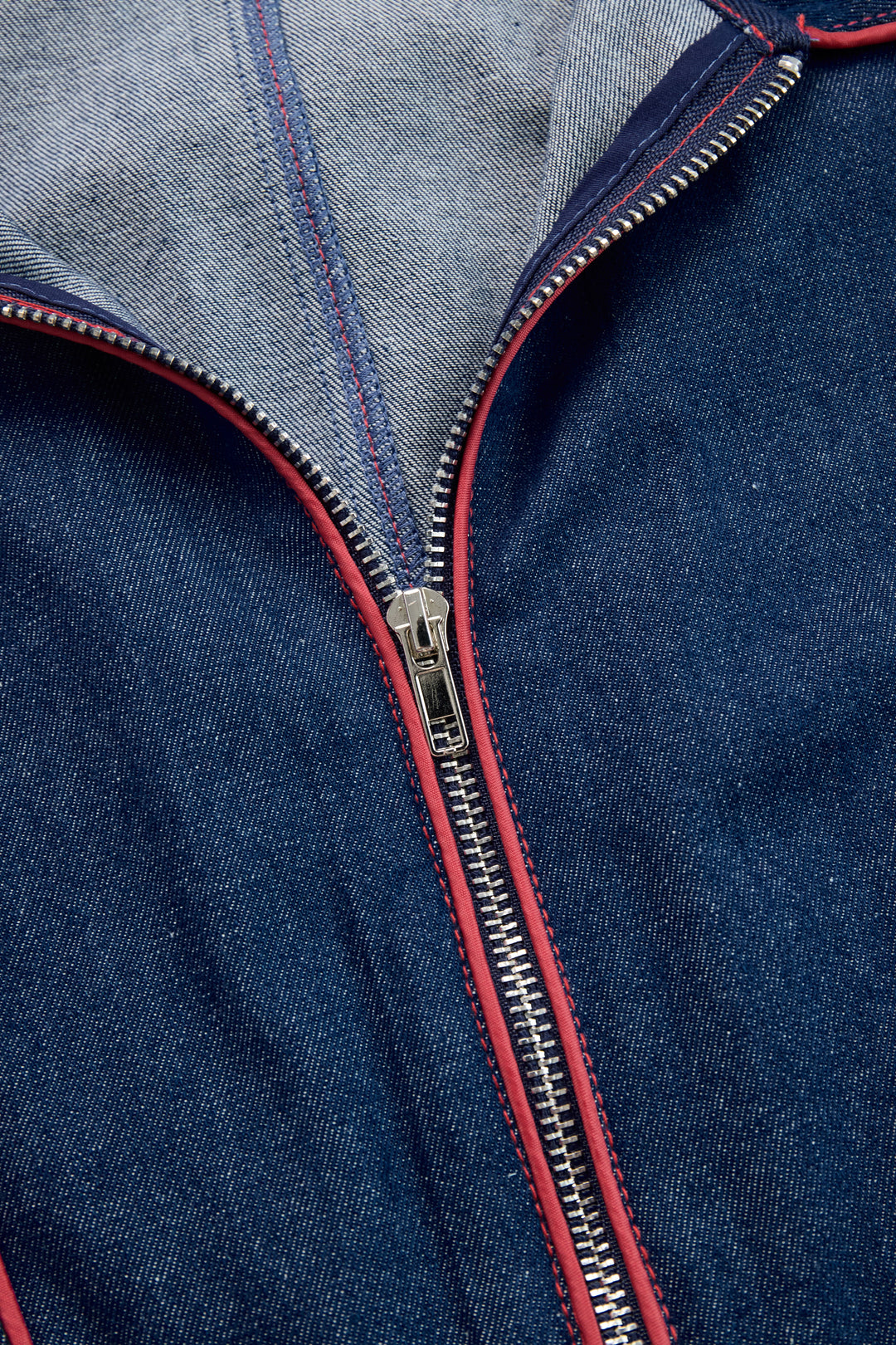 Zip pull and red piping detail on denim jumpsuit