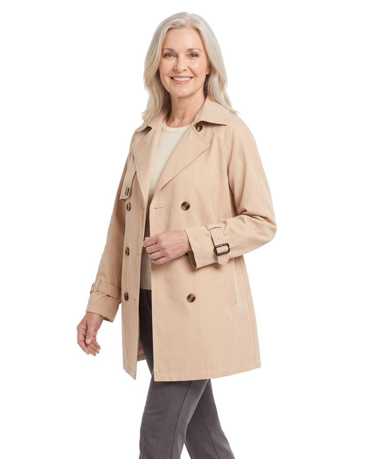 Woman wearing the khaki beige belted trench coat, three quarter walking pose
