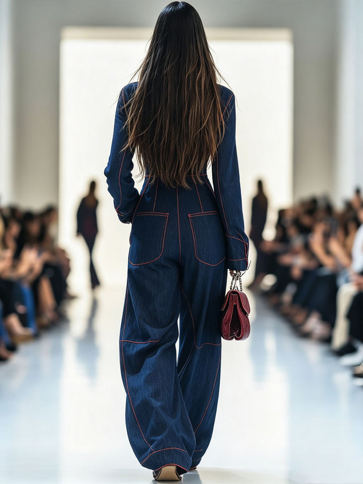 Denim jumpsuit back view with patch pockets and red stitching