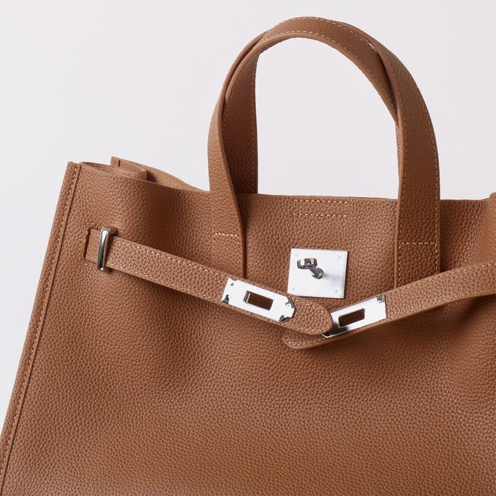 Close-up of pebbled full-grain leather and silver-tone hardware