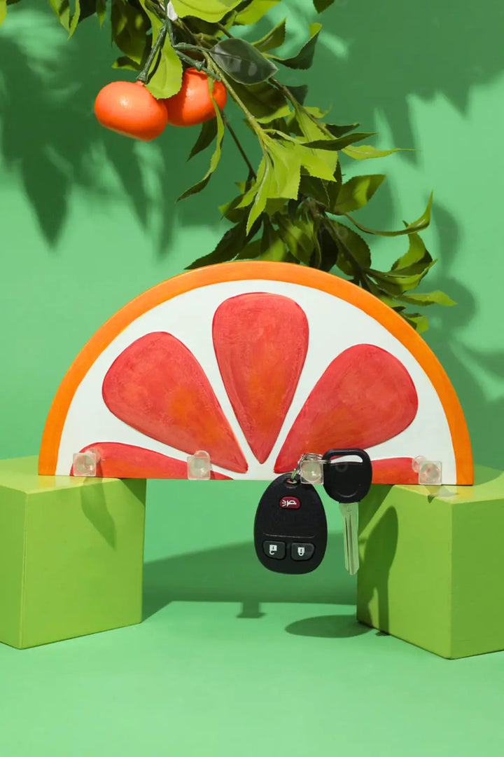 Blood orange wall key holder mounted by a doorway