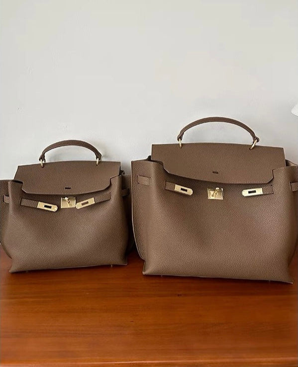 Leather satchel bag gold turn-lock closure close-up