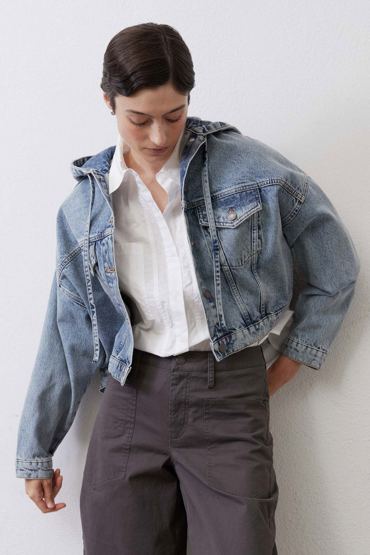 Close-up of denim jacket collar, hood drawstring and chest flap pockets