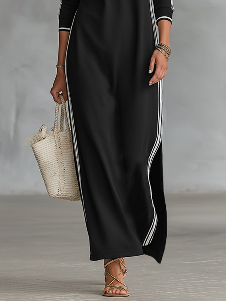 Detail of the side stripe and walking slit on the black maxi dress