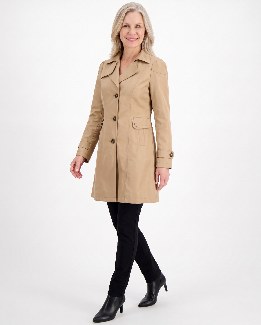Woman walking in the Clementine fitted mid-length trench coat in khaki