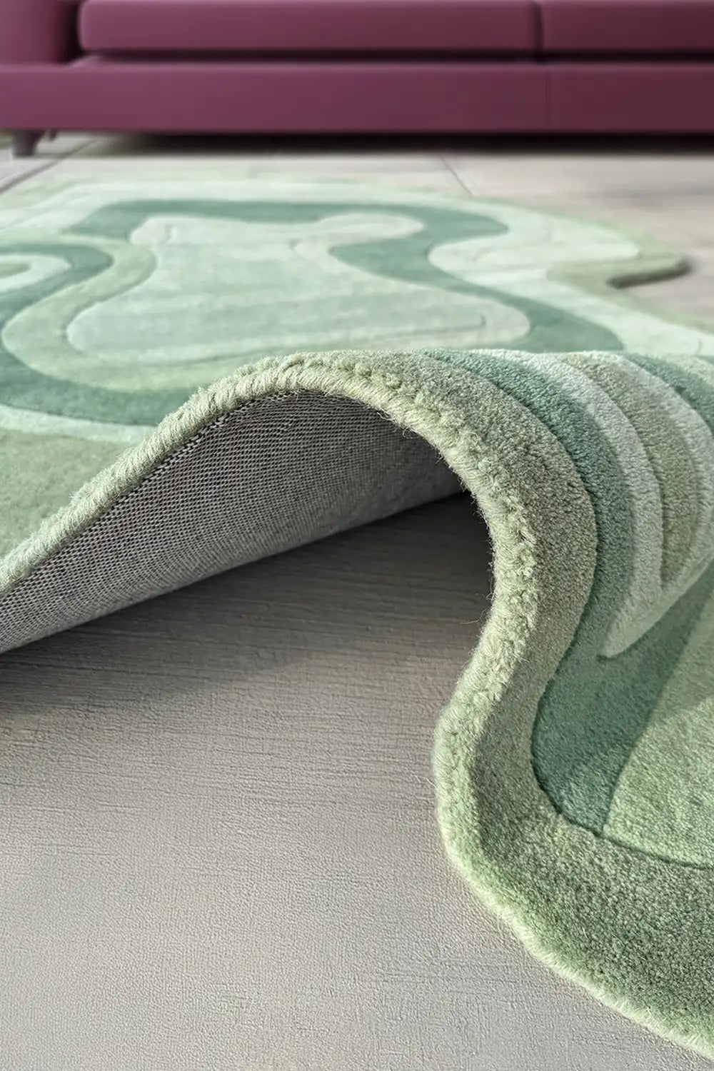 Sage organic wool area rug styled in a modern living room