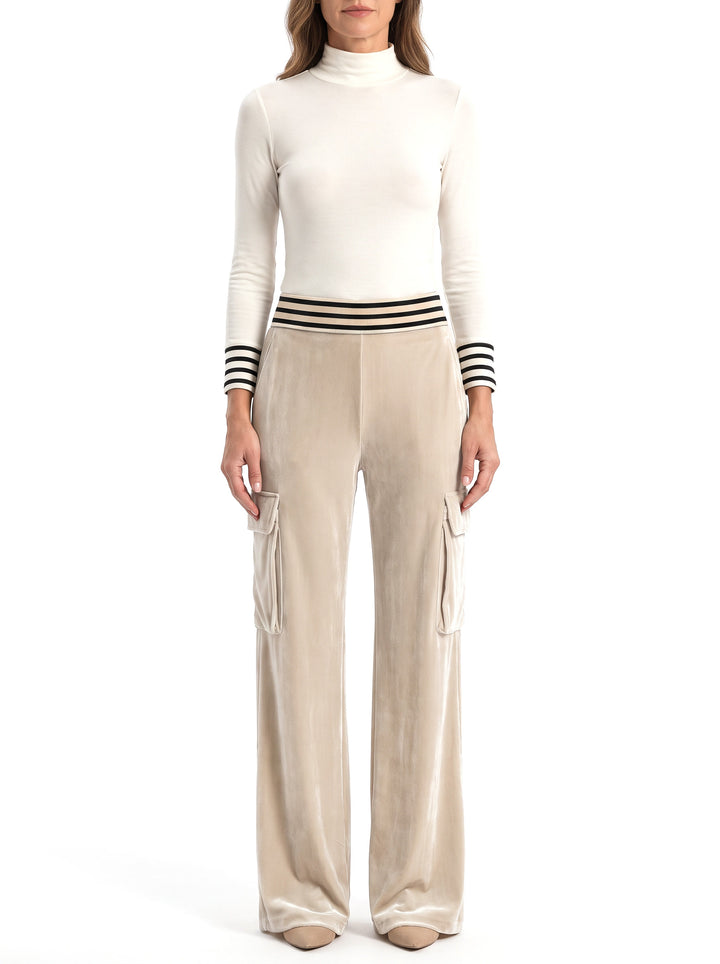 Woman wearing the Blanche-Minerva striped top and beige velvet wide-leg pants set