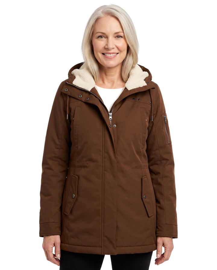 Woman wearing the brown hooded sherpa-lined zip coat, studio shot on white