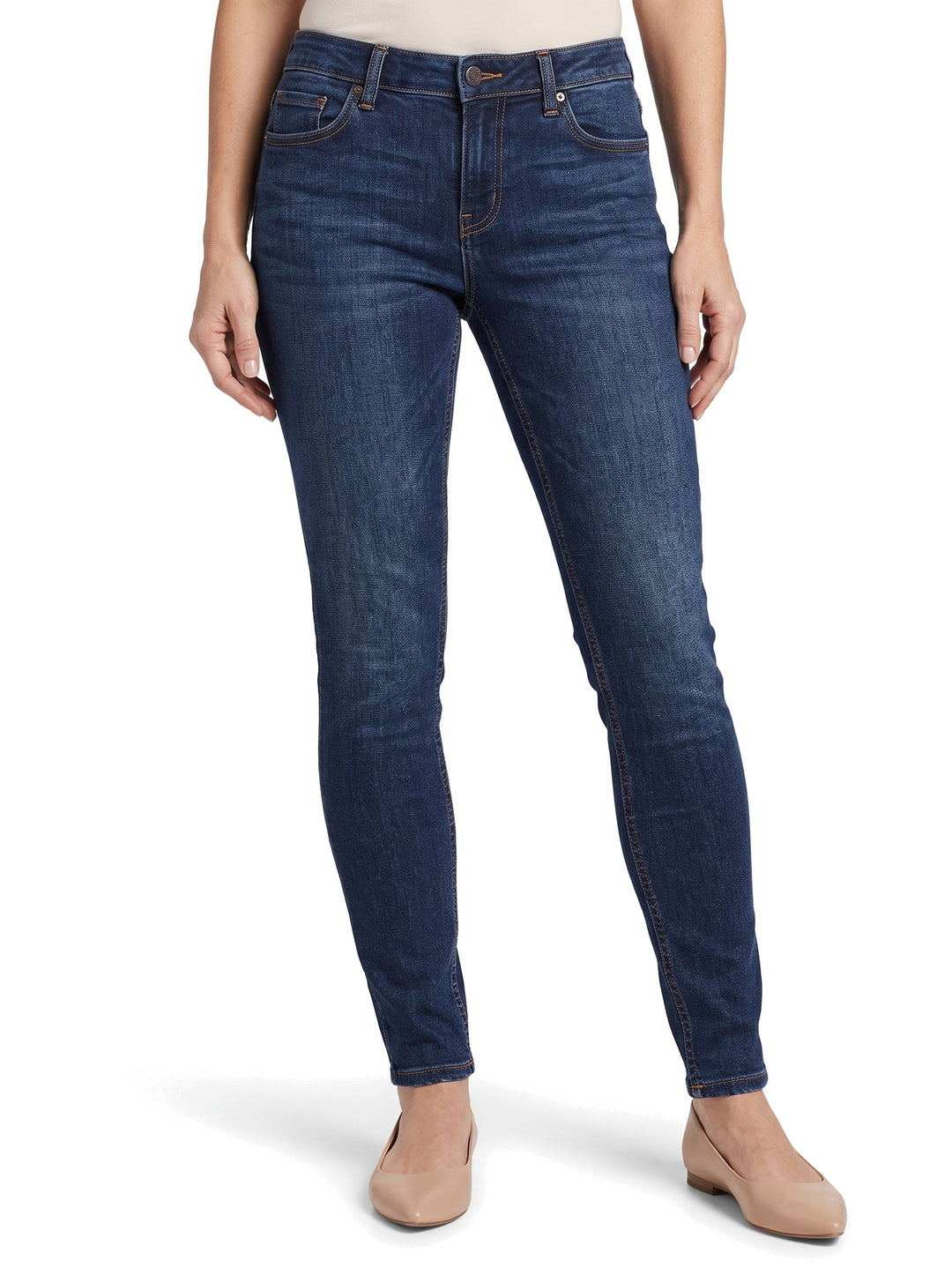 Woman wearing dark blue tapered skinny jeans, waist to feet studio shot