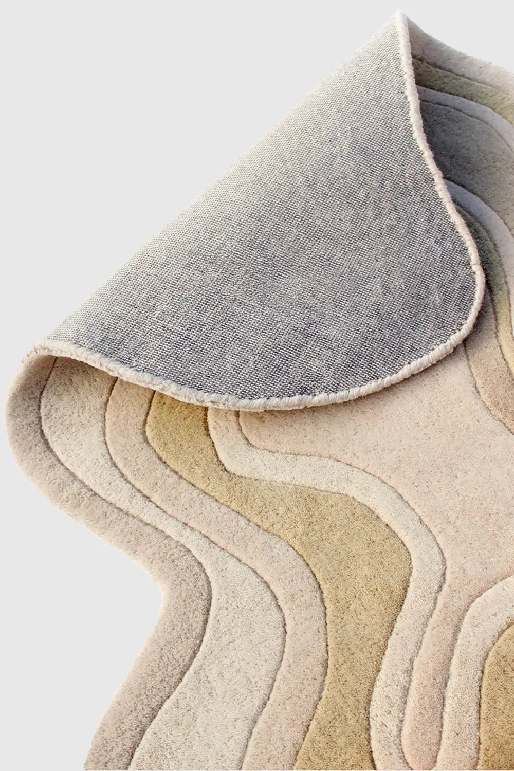 Hand-tufted wool rug finishing detail and sculpted pile
